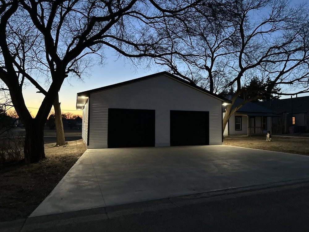 BlackRidge-built garage at twilight with finished concrete drive
